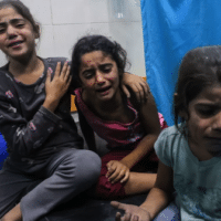 Palestinian children injured in an Israeli air strike await treatment at the Nasser hospital in Khan Yunis in southern Gaza, on 17 October 2023 (AFP)